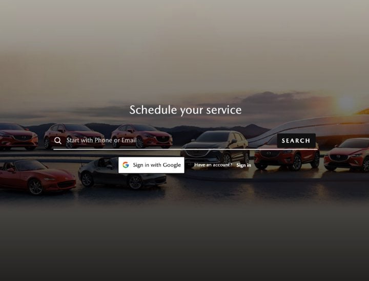 Website page with a search bar and Schedule your service text over various Mazda cars, including red and black models.